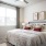 bedroom with a large window and night stands next to the bed
