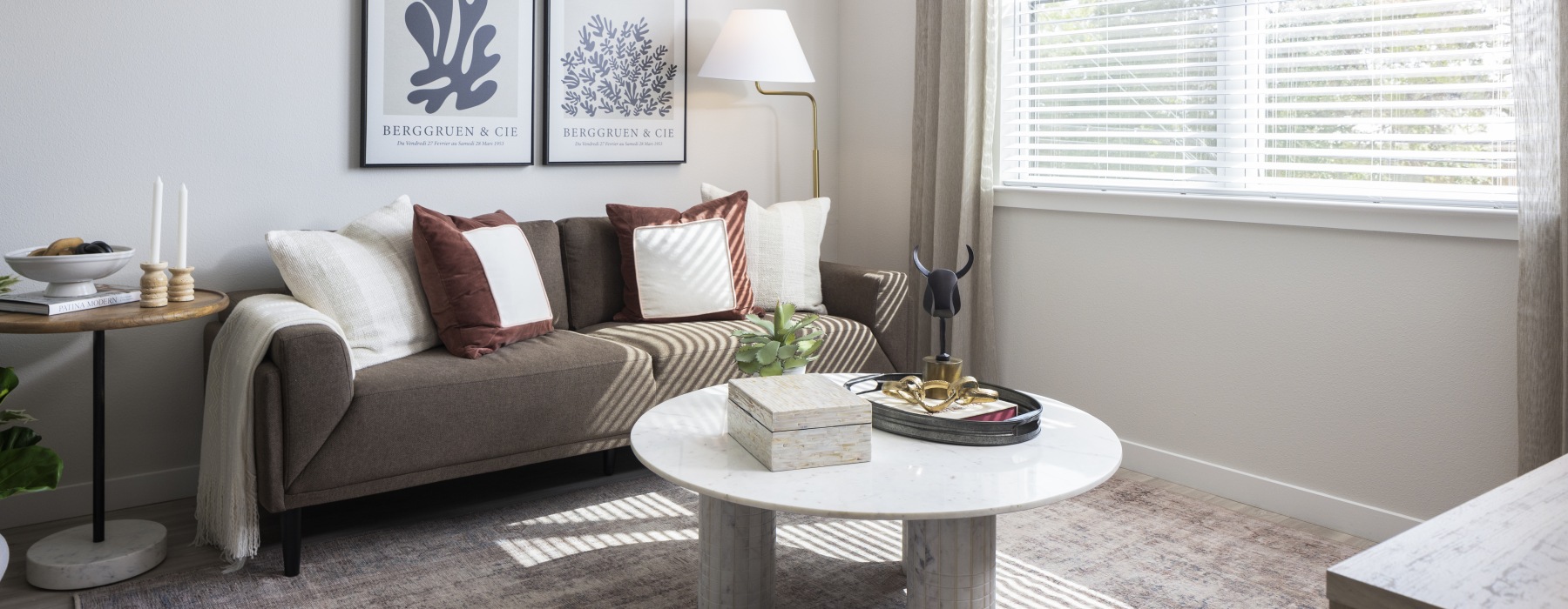 couch in living room with lamp and large window behind at broadstone amelia in houston tx