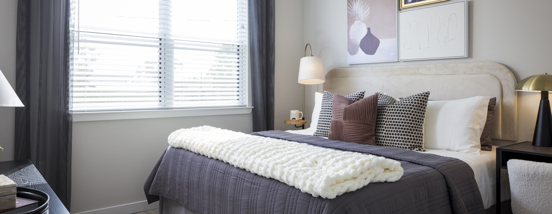 bedroom large bed with large window with a lamp at broadstone amelia in houston texas