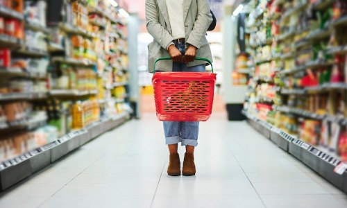 a woman holding a grocery store basket